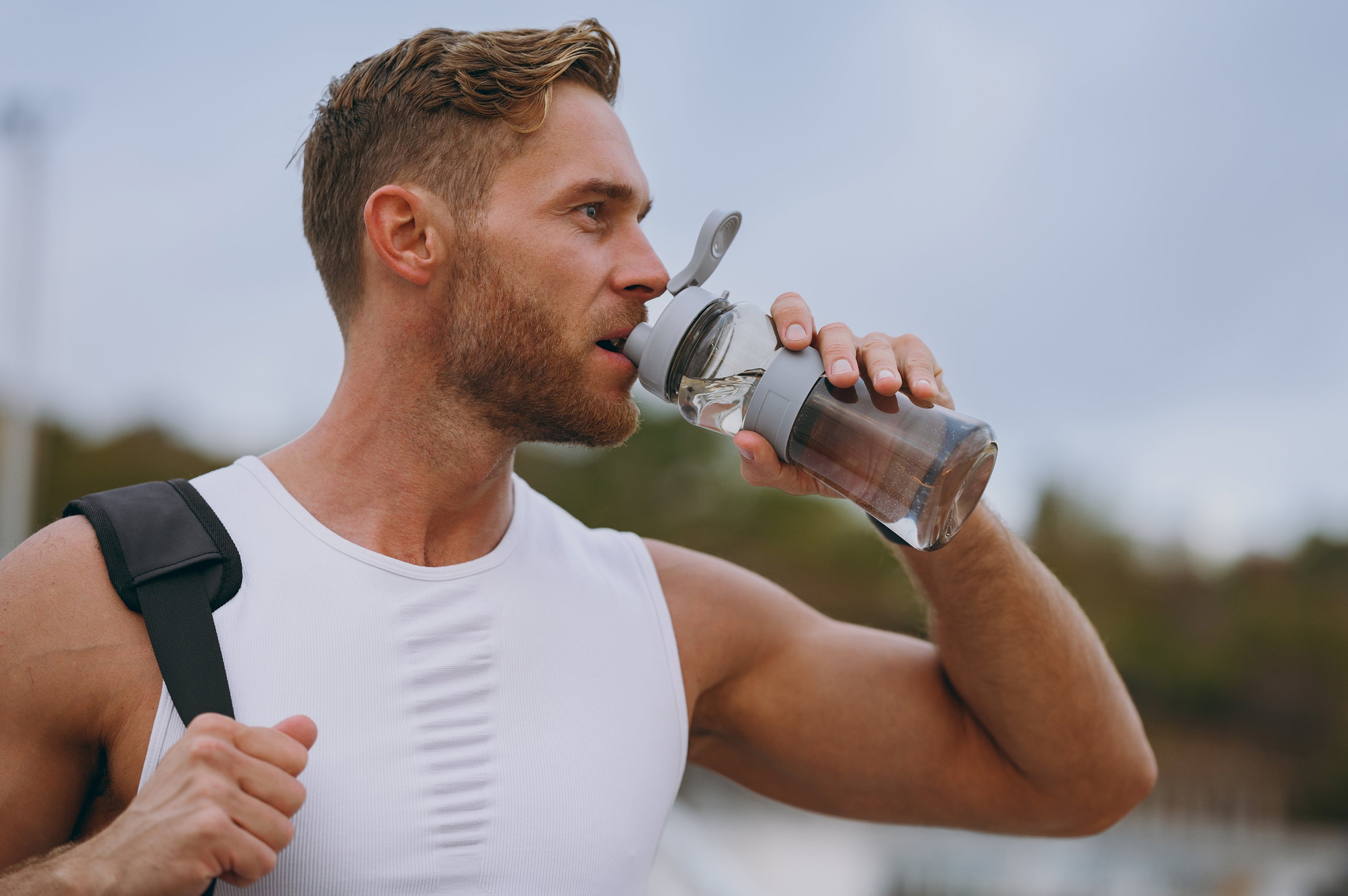athletic male drinking water
